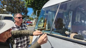 Closeup of working with windshield weather stripping